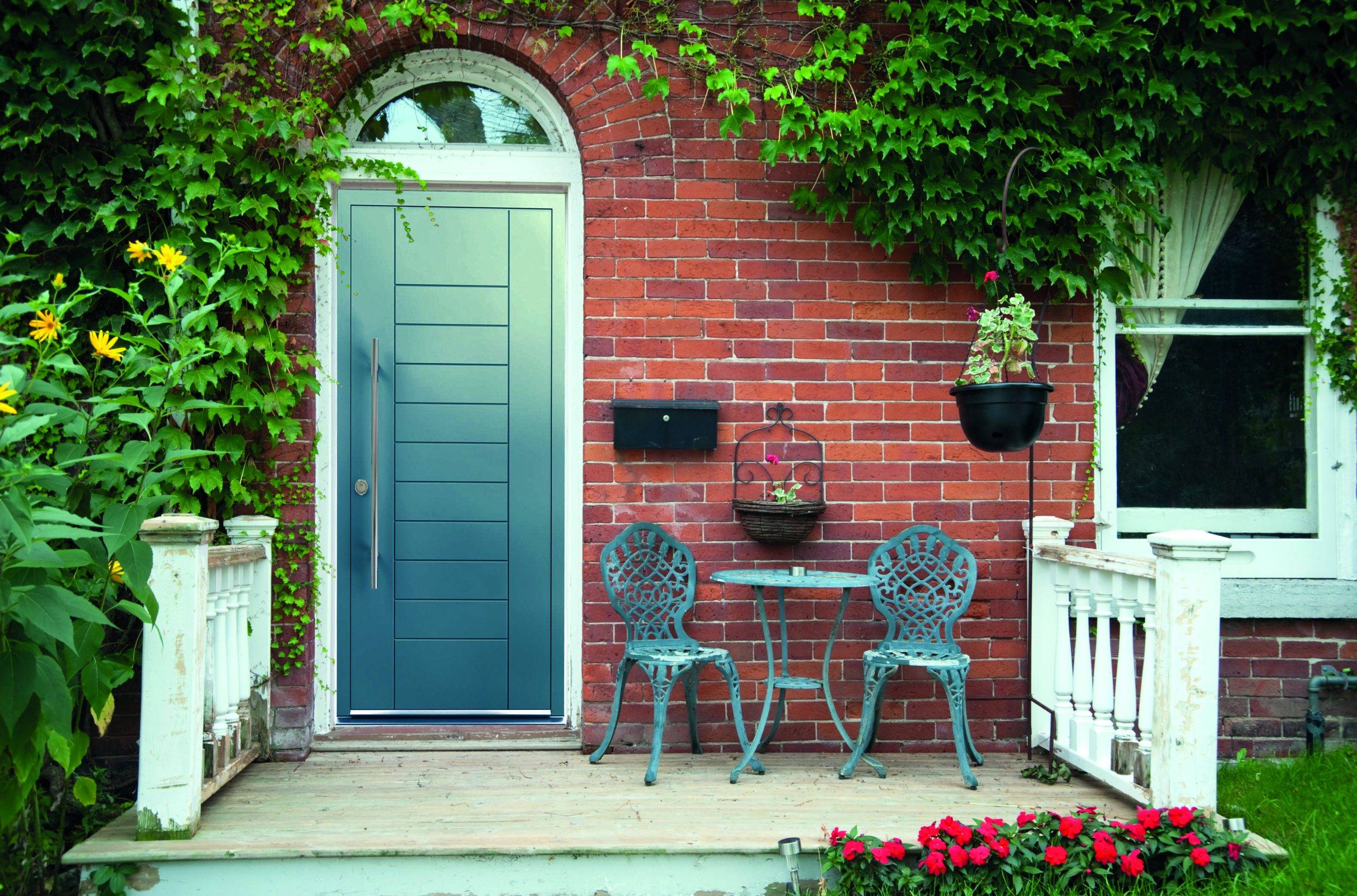 Red outside door with a patio and seating aluminium door prices near me